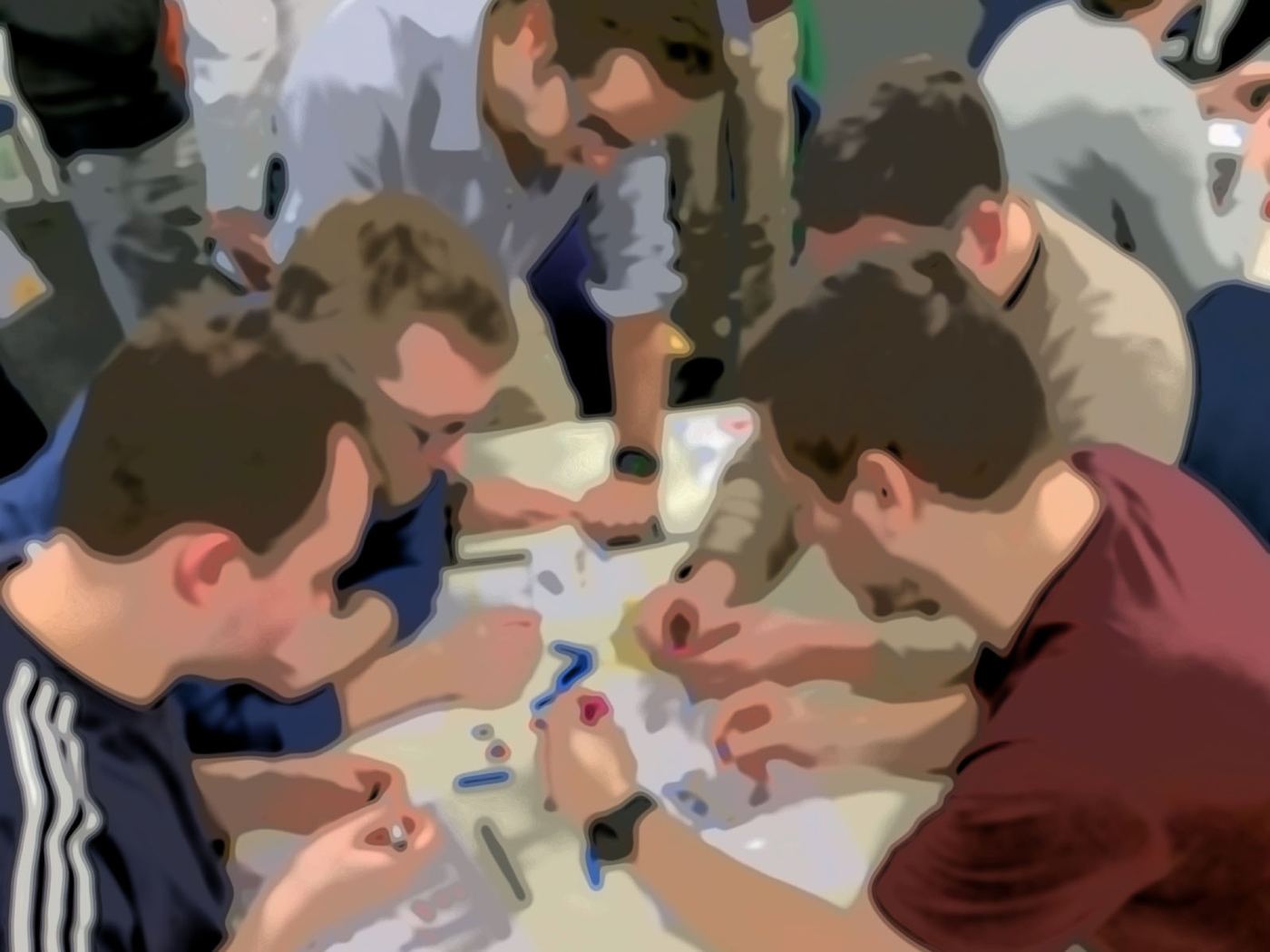 Four participants leaning over the table, building together
