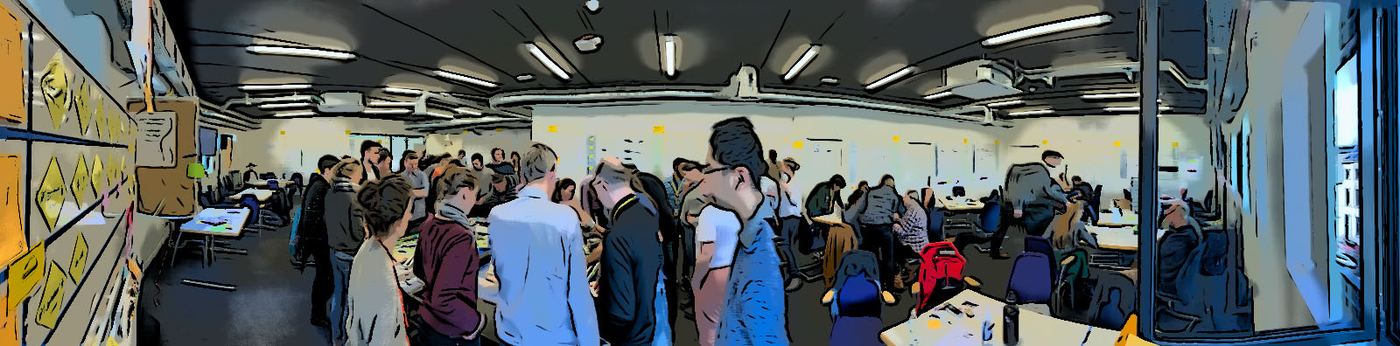 A full room of people at many tables during a large-scale LEAT session